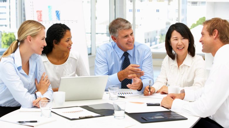 Group of People Sitting at Table with Life Insurance in New Rochelle