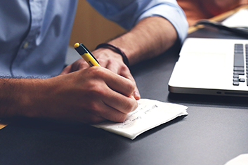 Man Writing up Employee Benefits for Group Dental Insurance in Long Island City